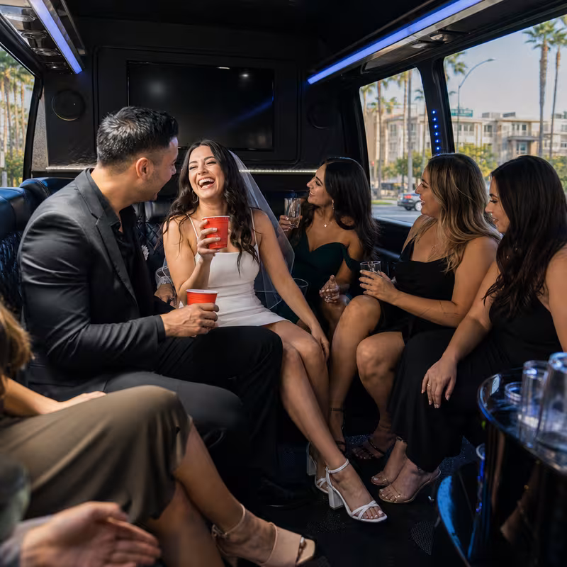 Party bus interior with wraparound leather seating and LED lighting in Anaheim
