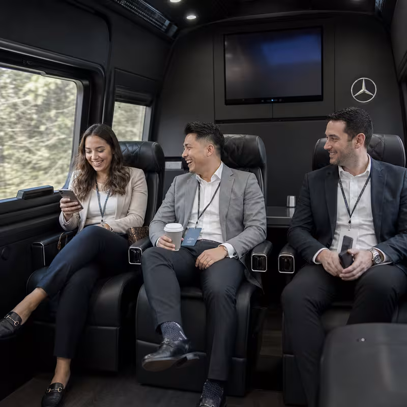 Group boarding a white charter bus for Corporate Transportation transportation in Anaheim