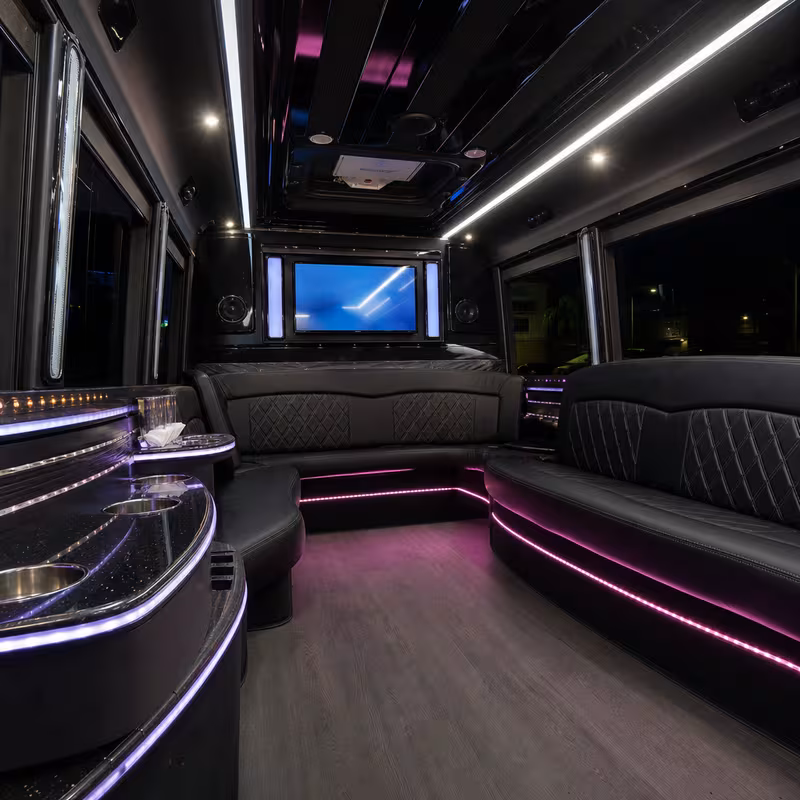 Party bus interior with wraparound leather seating and LED lighting in Anaheim