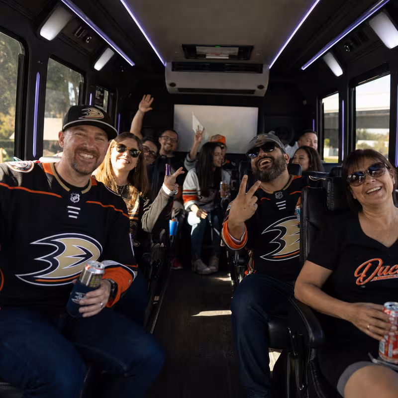 Group boarding a white charter bus for Sporting Event Transportation transportation in Anaheim
