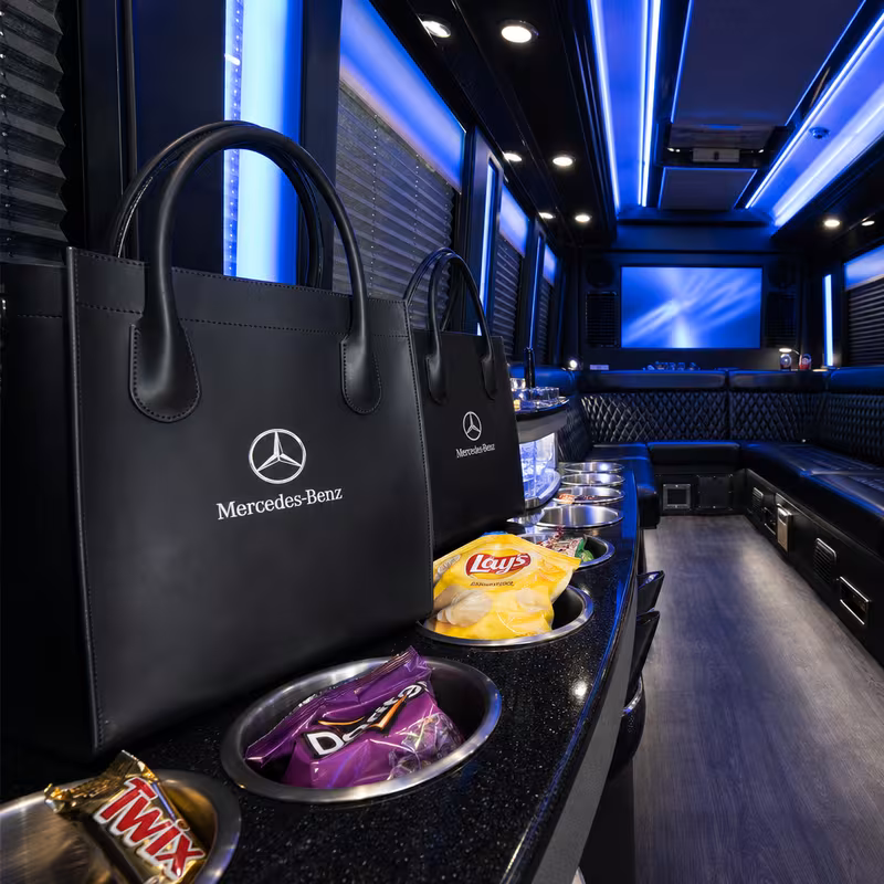 Party bus interior with wraparound leather seating and LED lighting in Anaheim